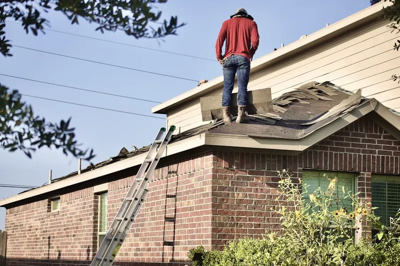 Professional roofer working on a residential roof in Grimesville